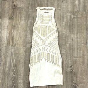 White dress with silver and gold beading/studs.